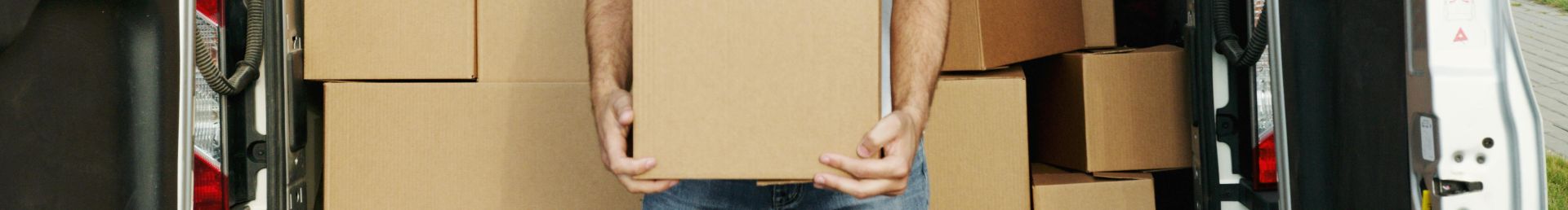 Man Smiling while Holding a Box